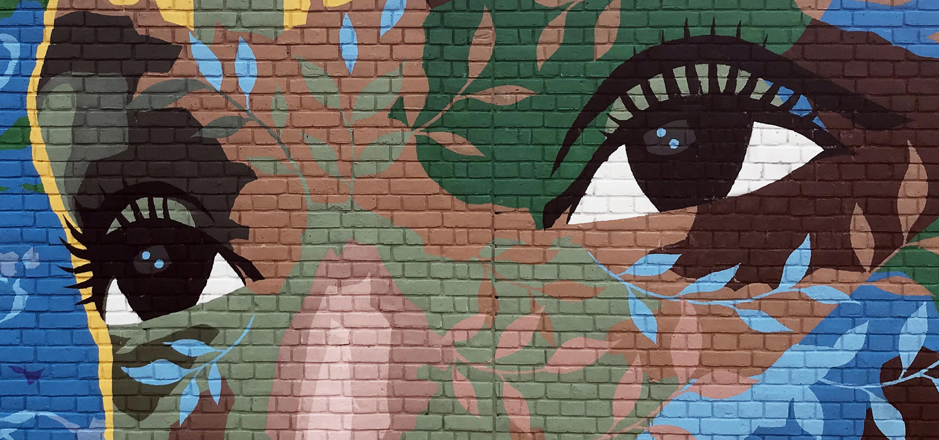 A person's face painted on a wall.